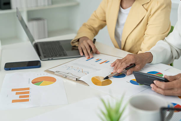 istock Business team calculate benefit, working woman, spreadsheets, graph financial development, bank accounts, statistics, economy, data analysis, investment analysis, stock exchange, rates income 2210518224