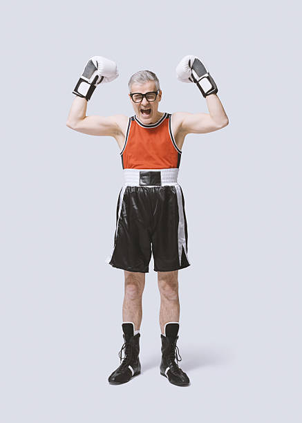 istock Funny skinny boxer showing off his muscles 2210518286