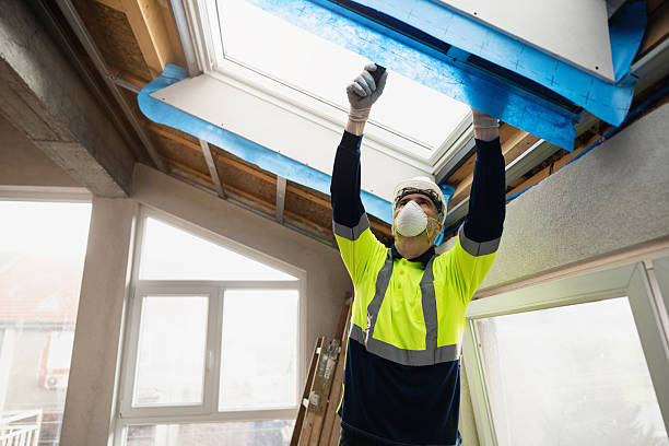 istock Worker installing plasterboards around attic roof window during home renovation 2210518820