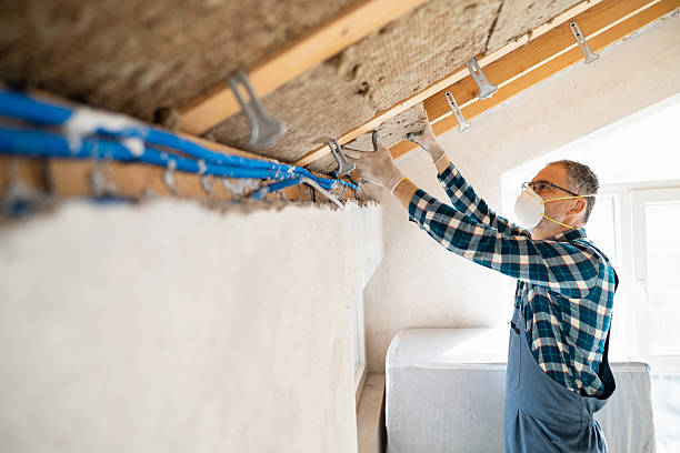 istock Worker insulating attic ceiling with mineral wool and aluminum profiles 2210518943