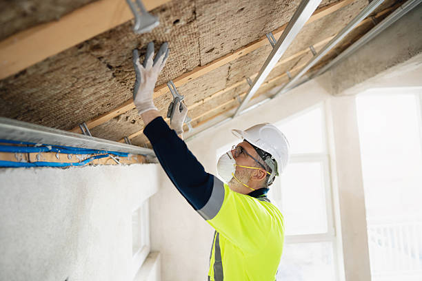 istock Construction worker installs mineral wool for ceiling insulation in unfinished building 2210519115