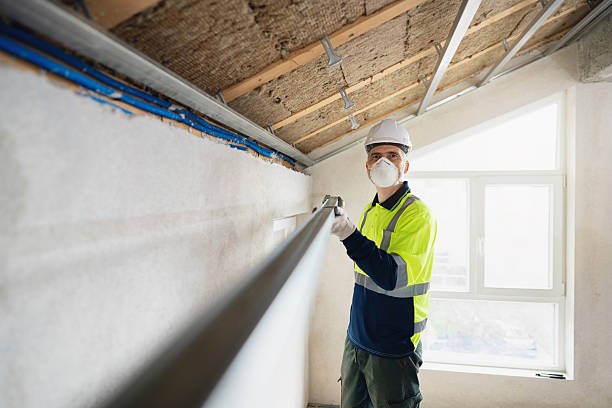 istock Worker installing ceiling aluminum profile and insulation in attic for energy-efficient building construction 2210519263