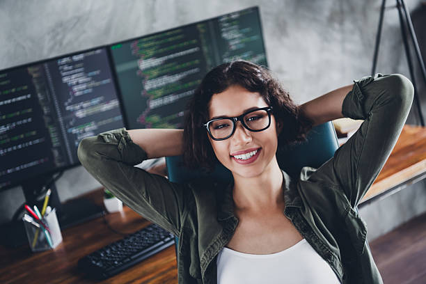 istock Confident software professional at work embracing a relaxing moment in a modern workspace with coding screens and diverse elements 2210519374