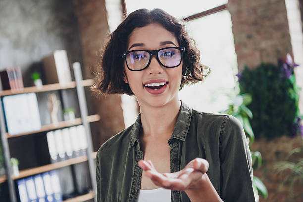 istock Casual female programmer in an office setting smiling with enthusiasm and confidence, representing a professional lifestyle 2210519377
