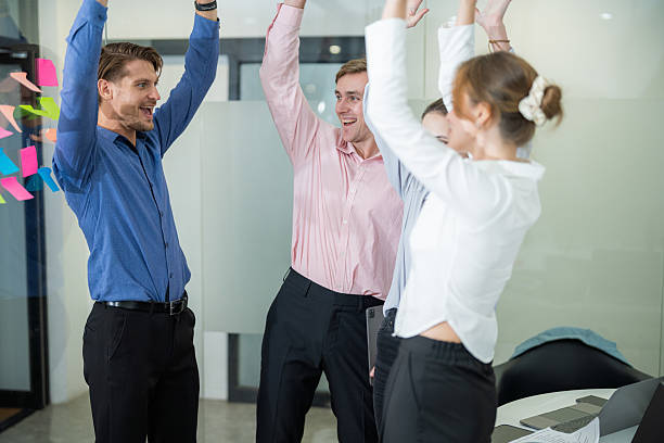 istock Team members celebrate success in a modern office setting during a productive meeting 2210519584