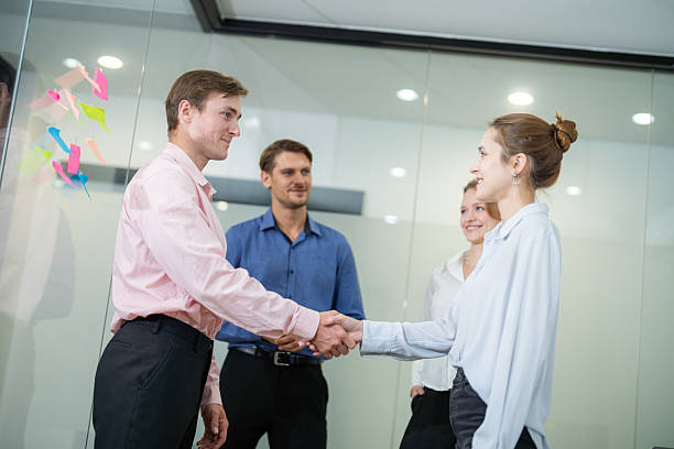 istock Business professionals engaging in a handshake and collaboration during a meeting in a modern office setting 2210519662