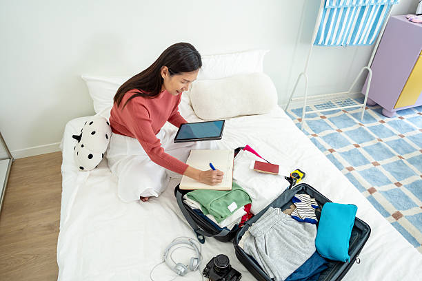 istock woman writing travel check list before tour 2210519830