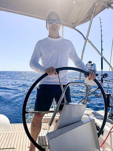 istock Skipper sailing on sailboat 2210520435