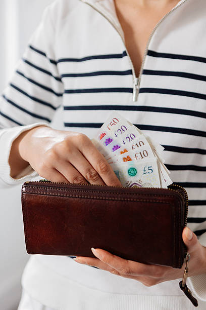 istock Woman hands holding money and wallet 2210520897