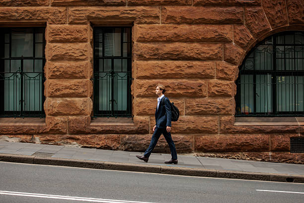 istock Young Professional with Backpack Walking in Sydney 2210522527