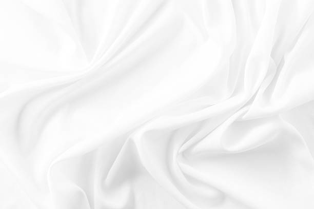 istock Soft and Smooth White Fabric Texture with Gentle Drapes and Wrinkles 2210522541