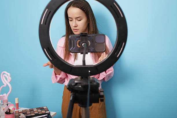istock Content Creator in Front of Phone Camera and Ring Light Sharing Makeup Tips Online 2210523229