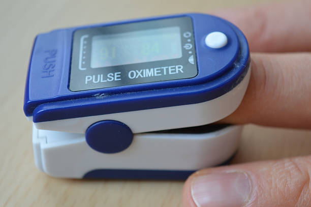 istock close-up pulse oximeter clipped on a finger displaying oxygen saturation heart rate digital screen device health medical equipment personal health monitoring educational materials healthcare 2210523558
