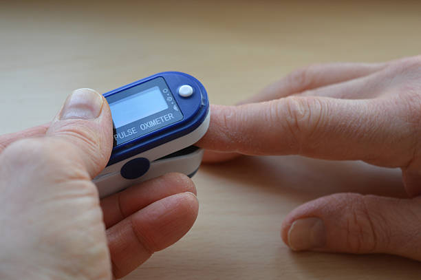 istock close-up pulse oximeter clipped on a finger displaying oxygen saturation heart rate digital screen device health medical equipment personal health monitoring educational materials healthcare 2210523577