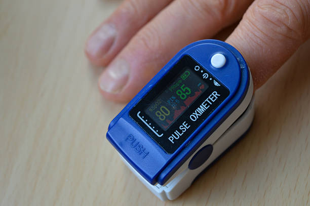 istock close-up pulse oximeter clipped on a finger displaying oxygen saturation heart rate digital screen device health medical equipment personal health monitoring educational materials healthcare 2210523578