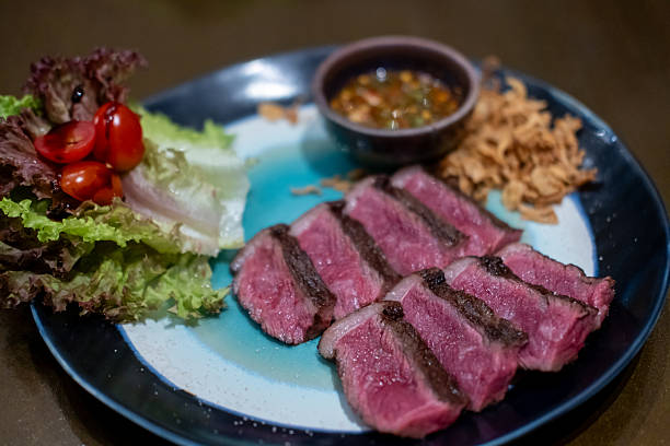 istock Medium rare sliced Picanha steak meat served on plate with vegetable 2210524864