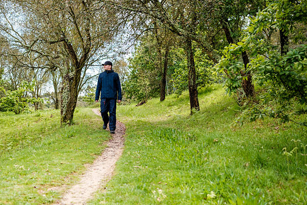 istock Man walking in a park during a cloudy day 2210526136