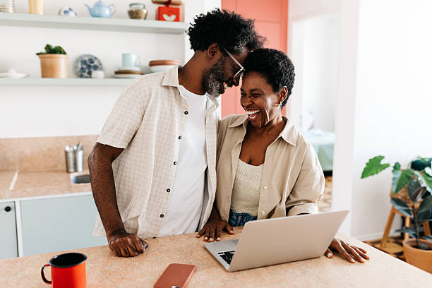 istock Affectionate black couple laughing and touching foreheads in the kitchen 2210526935