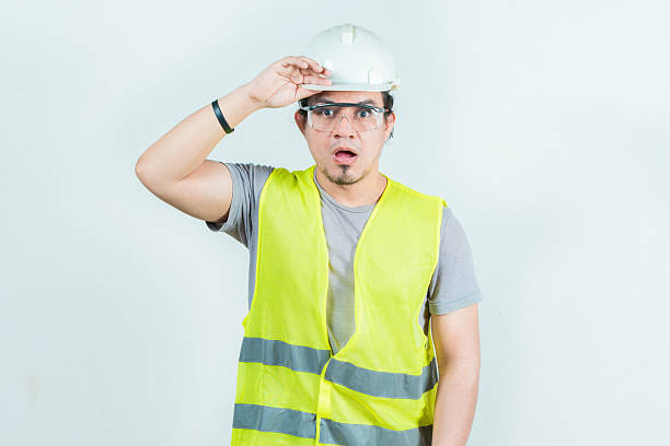 istock Surprised engineer looking into the distance isolated. Amazed latin engineer looking into the distance. Young engineer looking far away 2210527264