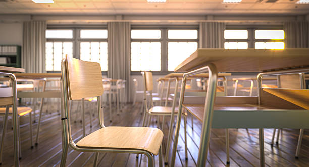 istock Empty classroom with wooden desks and chairs is waiting for students 2210529381