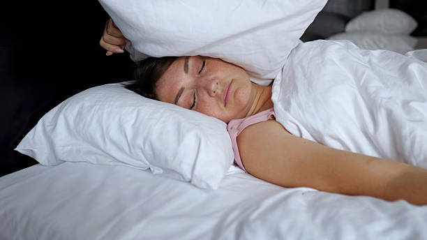 istock Irritated woman lies in bed suffering from insomnia 2210530661