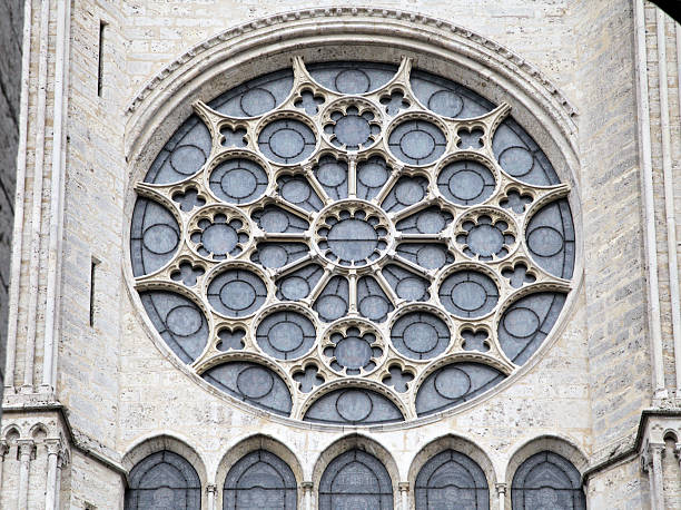 The stunning rose window of Notre-Dame de Chartres Cathedral showcases detailed craftsmanship in bright daylight.