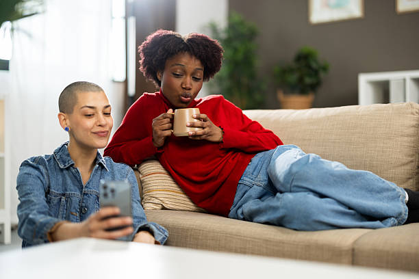 istock Two female students enjoying at their shared flat and taking selfies 2210531137