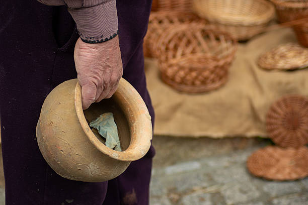 istock an senior potter artisan holding a pottery pot 2210531934