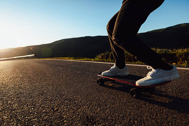 Young woman skateboarding in a city with a longboard. About 20 years old Caucasian redhead.