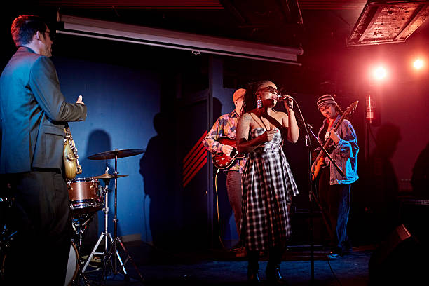 istock Black chanteuse fronting jazz band at nightclub 2210535955