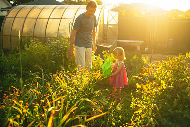 istock Child with grandfather gardening in spring or summer 2210537498