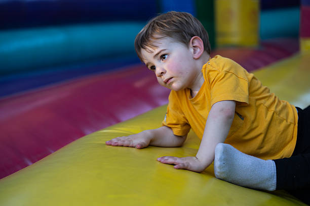 istock Child crawling on inflatable bouncy castle at playground 2210537763