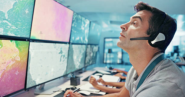 istock Computer, emergency service and man with headset for global security, dispatcher and operator. Telecommunication, surveillance maps and first responder on monitor for incident report, contact or help 2210543530