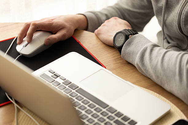 istock Man working behind a laptop wearing sport cozy clothing. Selective focus. 2210543771
