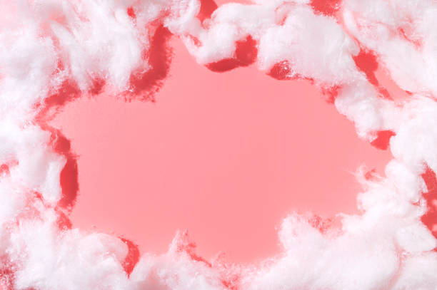 istock Frame from cotton wool on pink background top view. White fluffy natural material. Cotton background, wallpaper. Soft pieces of organic cotton wool for hygiene and medicine 2210545756