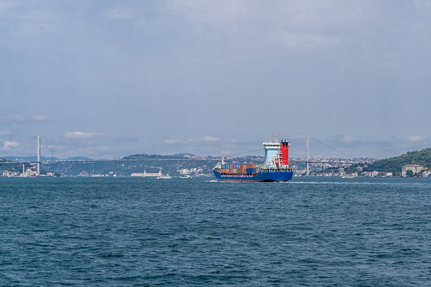 istock Container ship navigating through the Bosphorus Strait with city skyline in the background on a clear day 2210545888