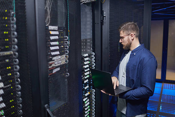 istock Technician Working in Data Center Monitoring Equipment 2210548522