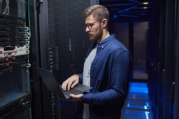 istock Managing Server Room With Laptop in Modern Data Center 2210548547