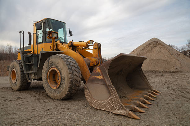 istock Heavy-Duty Yellow Loader with Large Shovel on Construction Site 2210550520