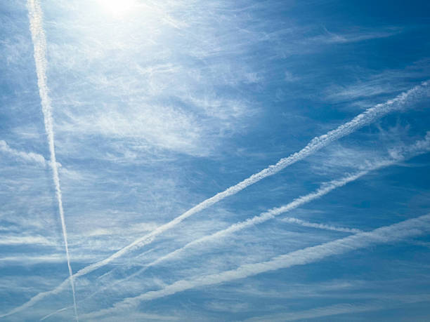 Contrail under the sun and blue sky
