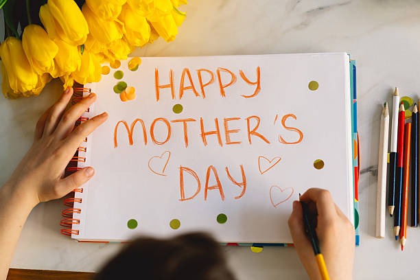 istock A boy diligently creating a heartfelt Mothers Day card 2210560427