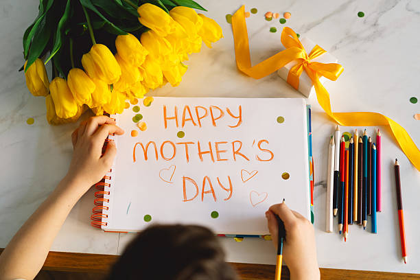 istock A boy diligently creating a heartfelt Mothers Day card 2210560428