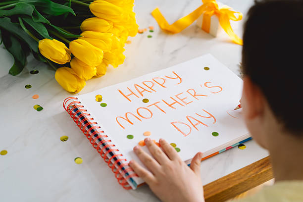 istock A boy diligently creating a heartfelt Mothers Day card 2210560430
