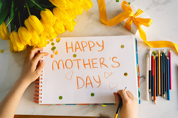 istock A boy diligently creating a heartfelt Mothers Day card 2210560608