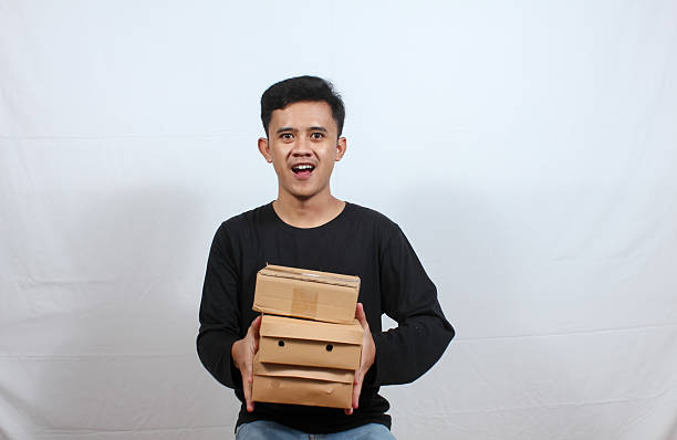 istock Asian man giving package to customer isolated on white background 2210561354