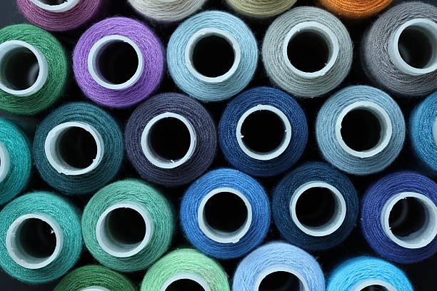 istock Spools of colorful sewing threads as background, top view 2210567286