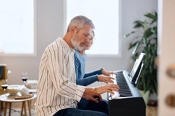 istock Side view of a couple playing piano 2210569336