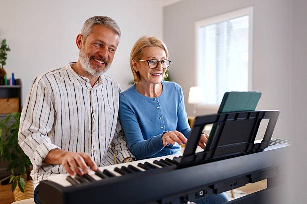 istock Husband and wife playing piano at home 2210569337