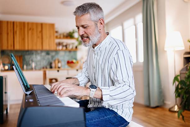 istock Modern man playing piano at home 2210569985