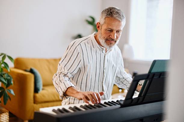 istock Happy male person playing piano 2210570011